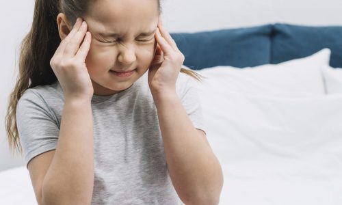 close-up-girl-sitting-bed-having-sever-pain-headache