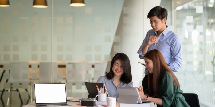 Business team briefed the concepts before the meeting with customers at the modern office equipped with laptop computer.